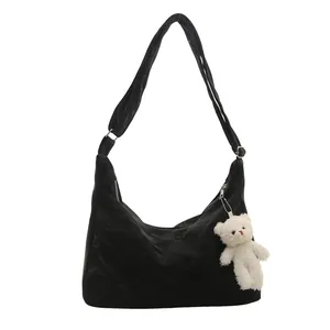 Black large capacity hobo shoulder bag with a cute white plush bear pendant decor