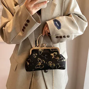 Vintage black shell handbag with gold butterfly embroidery and elegant metal chain strap