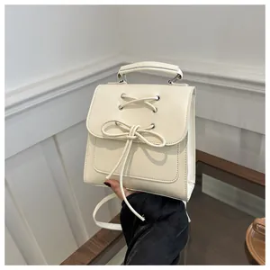 Detailansicht der beigen PU-Leder Minitasche mit Kreuzgurt und Schleifendekor