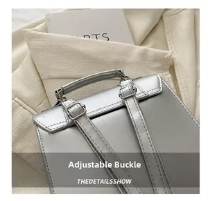 Detail of silver metallic leather bag with adjustable strap and silver metal buckle