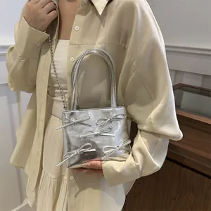 Silver bow mini tote bag with metallic finish and beaded chain strap for women