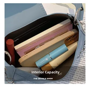 Detail view of large internal capacity showing phone, notebook and cosmetics inside
