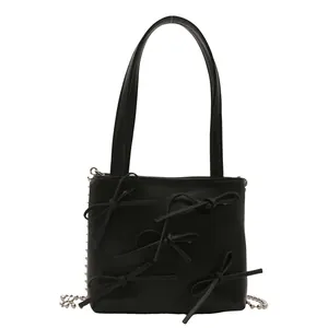 Black mini tote bag with decorative bows and silver bead chain strap for women