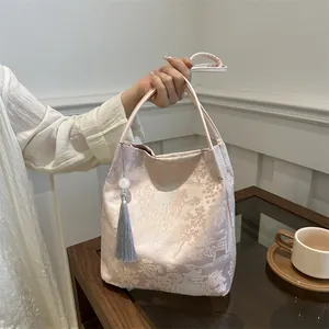 Pink jacquard canvas handbag with traditional Chinese landscape embroidery and silk tassel