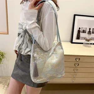 New Chinese jacquard canvas shoulder bag with golden embroidery and elegant grey tassel