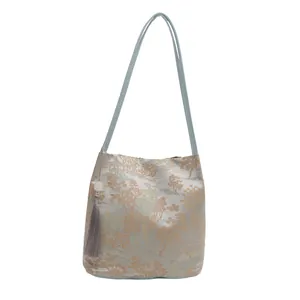 Blue jacquard canvas shoulder bag with traditional embroidery and tassel decoration