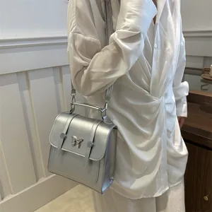Chic silver metallic mini square bag with butterfly clasp and versatile strap