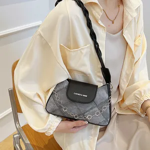 Chic grey denim underarm bag with black leather flap and floral chain strap for women