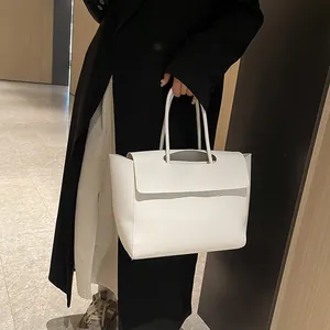 Minimalist white faux leather tote bag for women with sleek top handle and flap closure