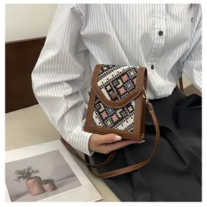 Detailed macro of a vintage ethnic style crossbody bag with colorful woven embroidery panels