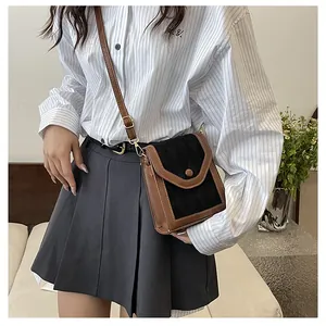 Detailed view of a vintage color-block crossbody bag with adjustable shoulder strap