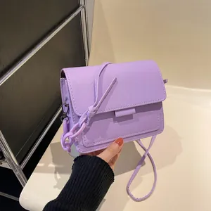 Minimalist purple crossbody bag with lychee grain leather texture and chain strap
