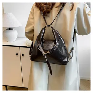 Detailed view of vintage dark brown faux leather multi-way backpack with metal straps