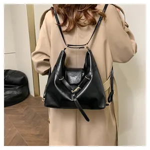 Detailed view of large black PU leather tote backpack showing soft texture and straps