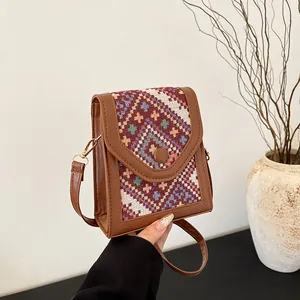 Retro geometric woven crossbody bag with brown faux leather trim and metallic buckle