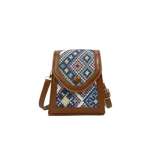 Crossbody phone bag with colorful ethnic embroidery and brown faux leather trim