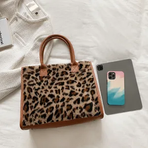 Leopard print plush tote bag shown with tablet and phone to demonstrate its large capacity