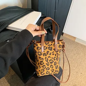 Vintage leopard print crossbody phone bag with brown leather handles and slim strap