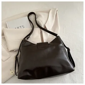 Detailed top view of dark brown faux leather shoulder bag with gold hardware and zipper