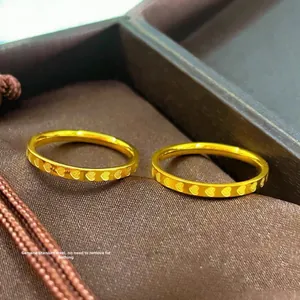 Minimalist gold-plated heart-engraved titanium steel couple rings in a jewelry box