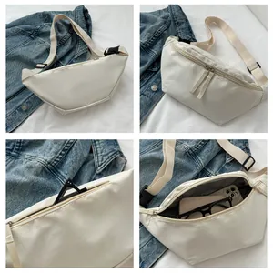 Close-up of cream crescent crossbody bag showing multi-compartments and large capacity