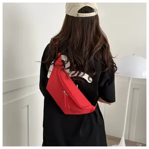 Close-up of red waterproof nylon sports waist bag with dual zipper shown on model's back