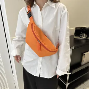 Bright orange crossbody bag for men and women showing on model in casual style