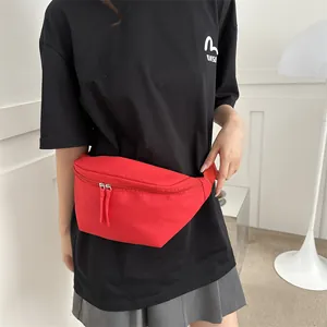 Bright red nylon crossbody waist bag with double zippers for casual outdoor use