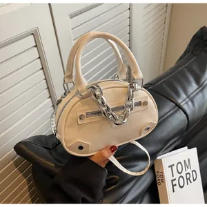 Detail of off-white lychee pattern PU leather mini bag with silver chain and dual handles