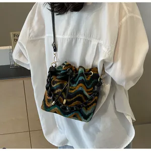Detalle del bolso bombonera de punto bohemio con motivos de ondas de colores