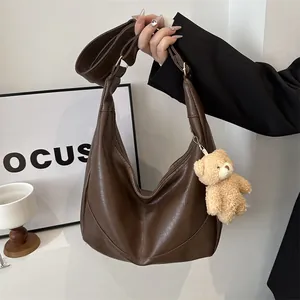 Large dark brown soft leather hobo bag with adjustable strap and bear pendant detail