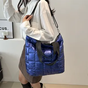 Blue quilted tote bag with metallic finish and adjustable strap for commuting