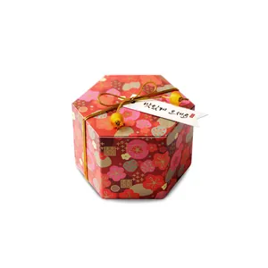 Boîte à bonbons hexagonale rouge de mariage avec fleurs dorées et nœud décoratif