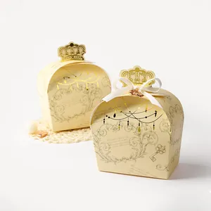 Detail of crown-shaped cream gift box with vintage gold pattern and white silk bow