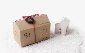 Detail of house-shaped kraft paper gift box with red twine and creative house tag