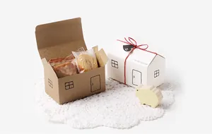 House-shaped kraft and white gift boxes with handmade cookies and heart tags