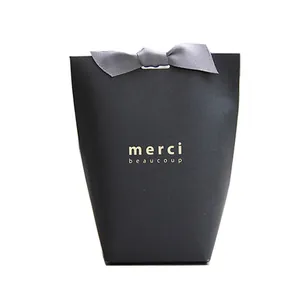 Premium black foldable paper gift bag with grey ribbon bow and gold merci beaucoup text