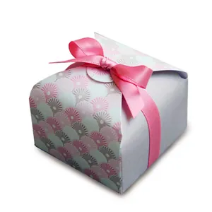 Detailed view of square gift box with pink shell patterns and a satin ribbon bow
