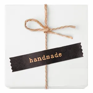 Minimalist white gift box with brown twine bow and black handmade adhesive seal sticker
