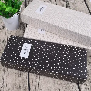 Three square cardboard drawer gift boxes with merci BEAUCOUP labels in assorted patterns