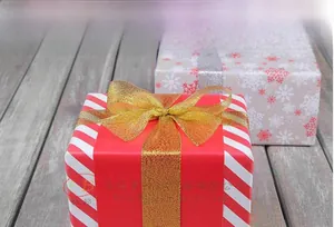 Metallic gold brocade ribbon tied in a bow on a gift box with a textured woven finish