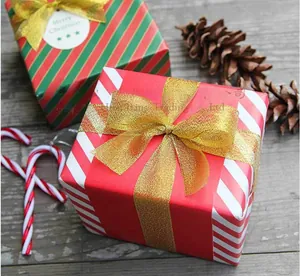 Christmas gift boxes with diagonal stripes and elegant gold metallic ribbon bows