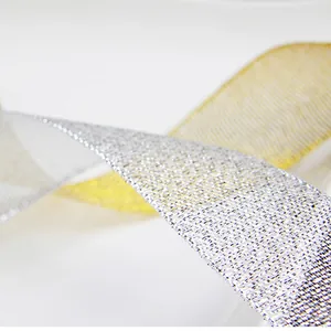 Close-up of metallic gold and silver ribbons with sparkling texture for gift wrapping