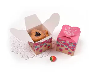 Macro detail of strawberry paper gift box with heart closure and printed patterns