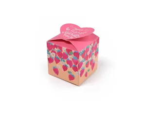 Detail of pink strawberry gift box with heart-shaped closure and decorative text
