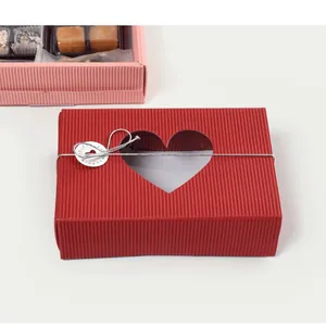 Red corrugated gift box with heart window and silver decorative cord for packaging