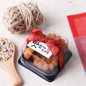 Traditional Yakgwa snack in gift box with red cloud pattern ribbon and Korean card