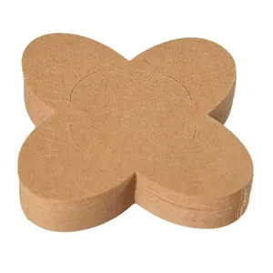 Cross-shaped brown kraft paper chocolate wrappers stacked on a white background
