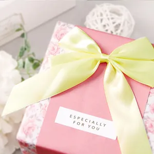 Pink floral gift box with large pale yellow satin ribbon bow and special label