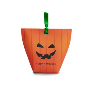 Creative Halloween pumpkin gift box with orange jack-o-lantern face and green ribbon bow